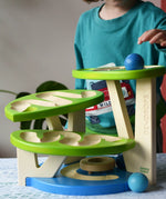 Child playing with the Bajo Dewdrop, Coloured wooden ball run.