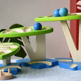 Child playing with the Bajo Dewdrop, Coloured wooden ball run.