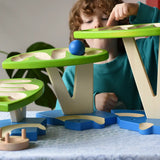 Child playing with the Bajo Dewdrop, Coloured wooden ball run.