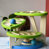 Child playing with the Bajo Dewdrop, Coloured wooden ball run.