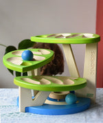 Child playing with the Bajo Dewdrop, Coloured wooden ball run.