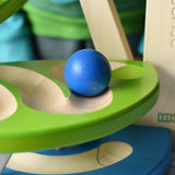 Close up of a blue wooden ball rolling down the track on the Bajo Dewdrop, Coloured wooden ball run.