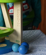 Three blue wooden balls paced besides the Bajo Dewdrop, Coloured wooden ball run.