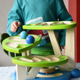 Child playing with the Bajo Dewdrop, Coloured wooden ball run.