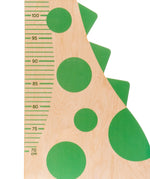 Close up of the measure markings on the Bajo dinosaur measuring growth chart.