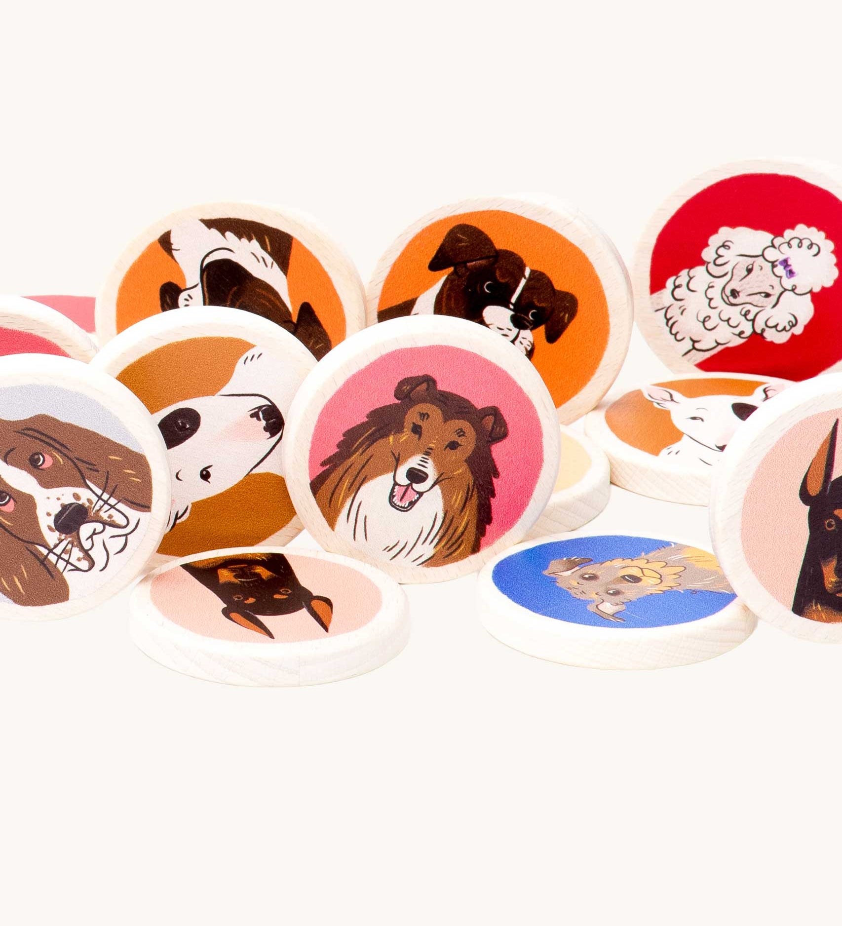 A close up of some of the wooden disc pieces included in the Bajo Dogs Memory Game. A set of 32 wooden discs featuring 16 different dog breeds printed on one side. These heirloom quality toys by Bajo are part of a wide range of wooden toys available here at Babipur.
