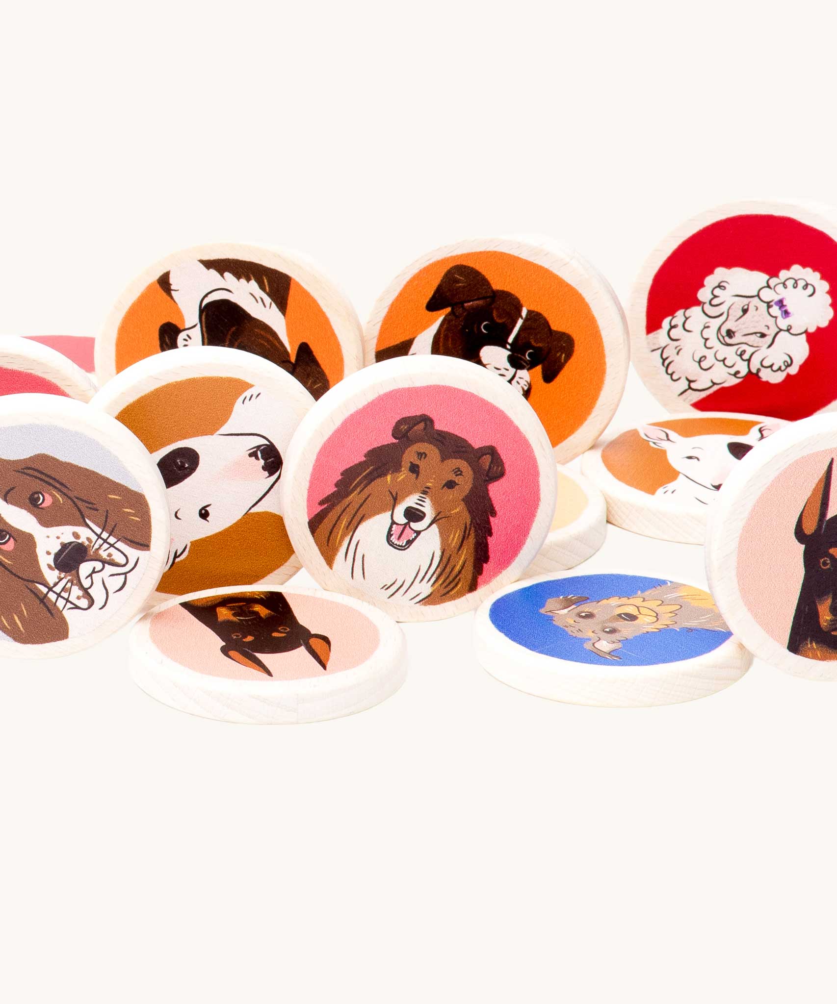 A close up of some of the wooden disc pieces included in the Bajo Dogs Memory Game. A set of 32 wooden discs featuring 16 different dog breeds printed on one side. These heirloom quality toys by Bajo are part of a wide range of wooden toys available here at Babipur.