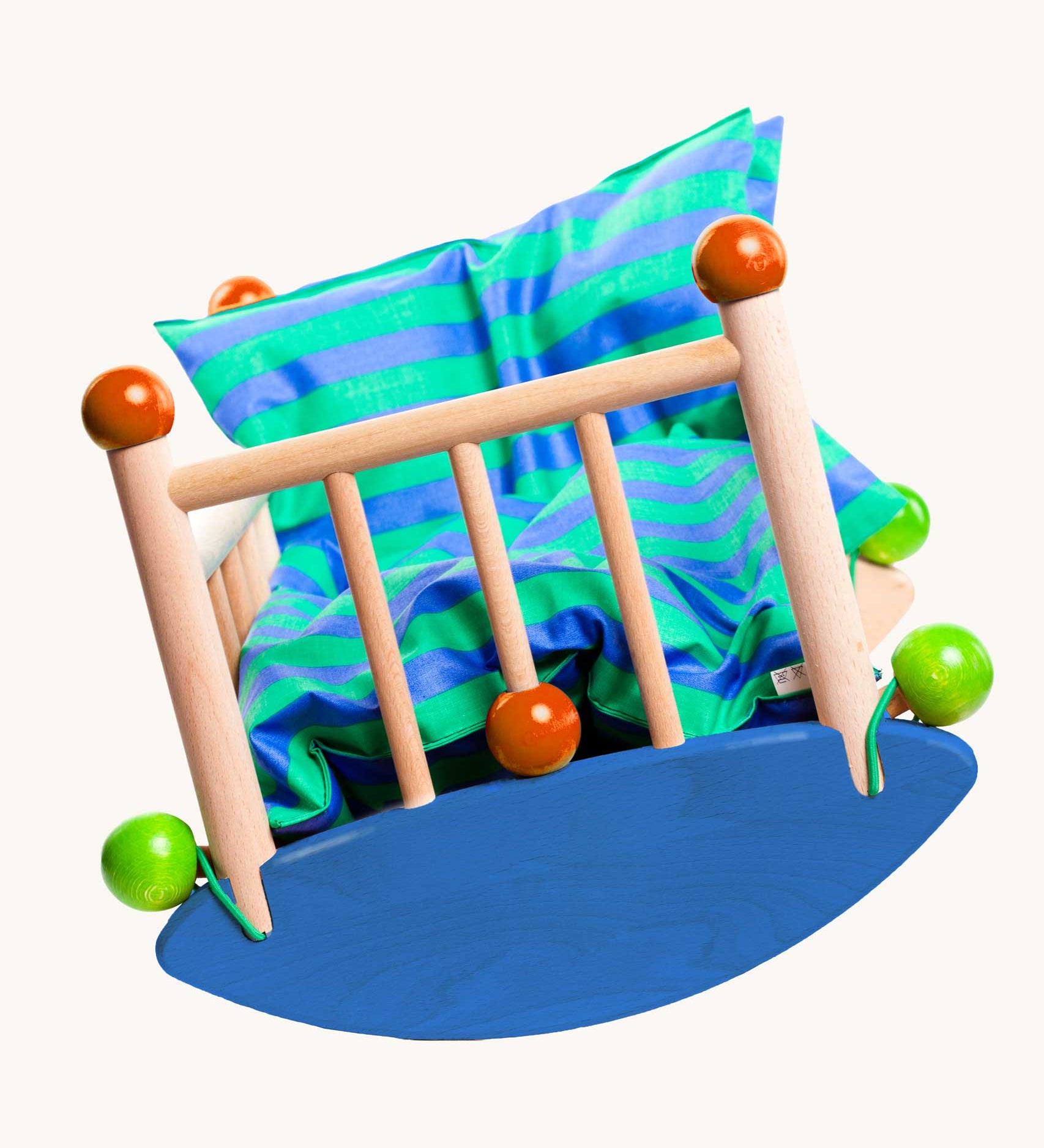 An image of the front of the Bajo wooden cot showing that the half circular base can rock from side to side. Bajo dolls wooden cot. These heirloom quality toys by Bajo are part of a wide range of wooden toys available here at Babipur.