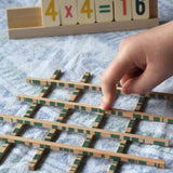 Bajo toys wooden easy maths learning set. Child placing their finger on the pieces that cross.