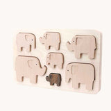 Bajo elephant puzzle sorter. A wooden frame with 7 elephant shaped figures placed inside. These heirloom quality toys by Bajo are part of a wide range of wooden toys available here at Babipur. 