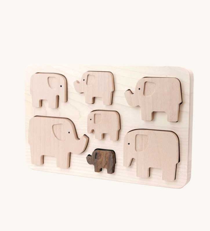 Bajo elephant puzzle sorter. A wooden frame with 7 elephant shaped figures placed inside. These heirloom quality toys by Bajo are part of a wide range of wooden toys available here at Babipur. 