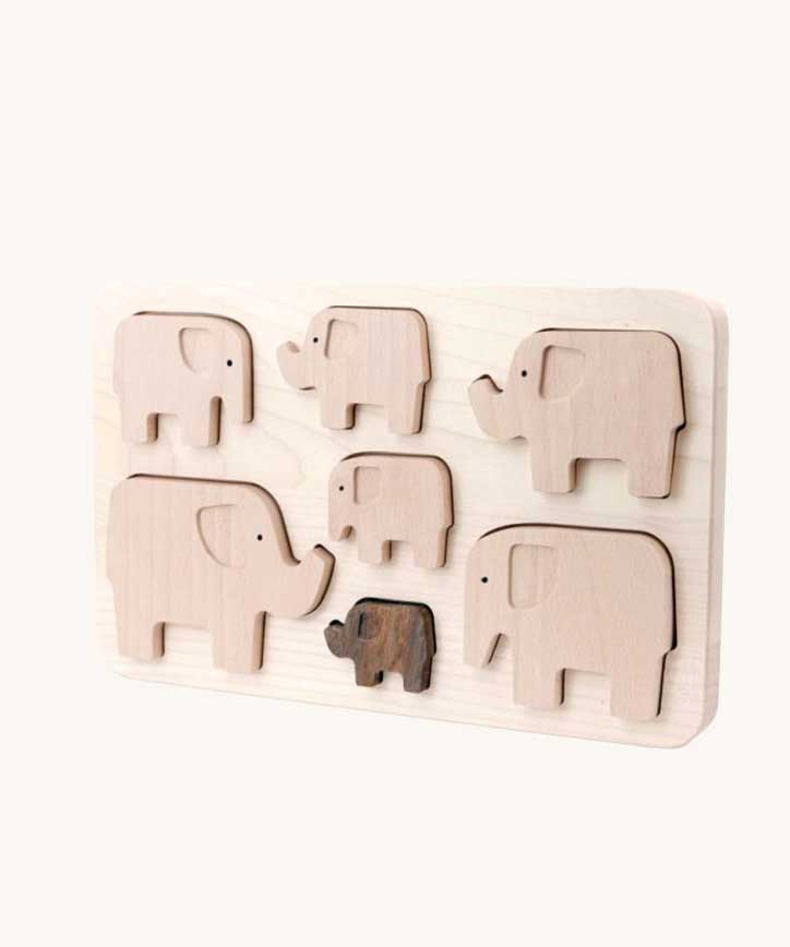 Bajo elephant puzzle sorter. A wooden frame with 7 elephant shaped figures placed inside. These heirloom quality toys by Bajo are part of a wide range of wooden toys available here at Babipur. 
