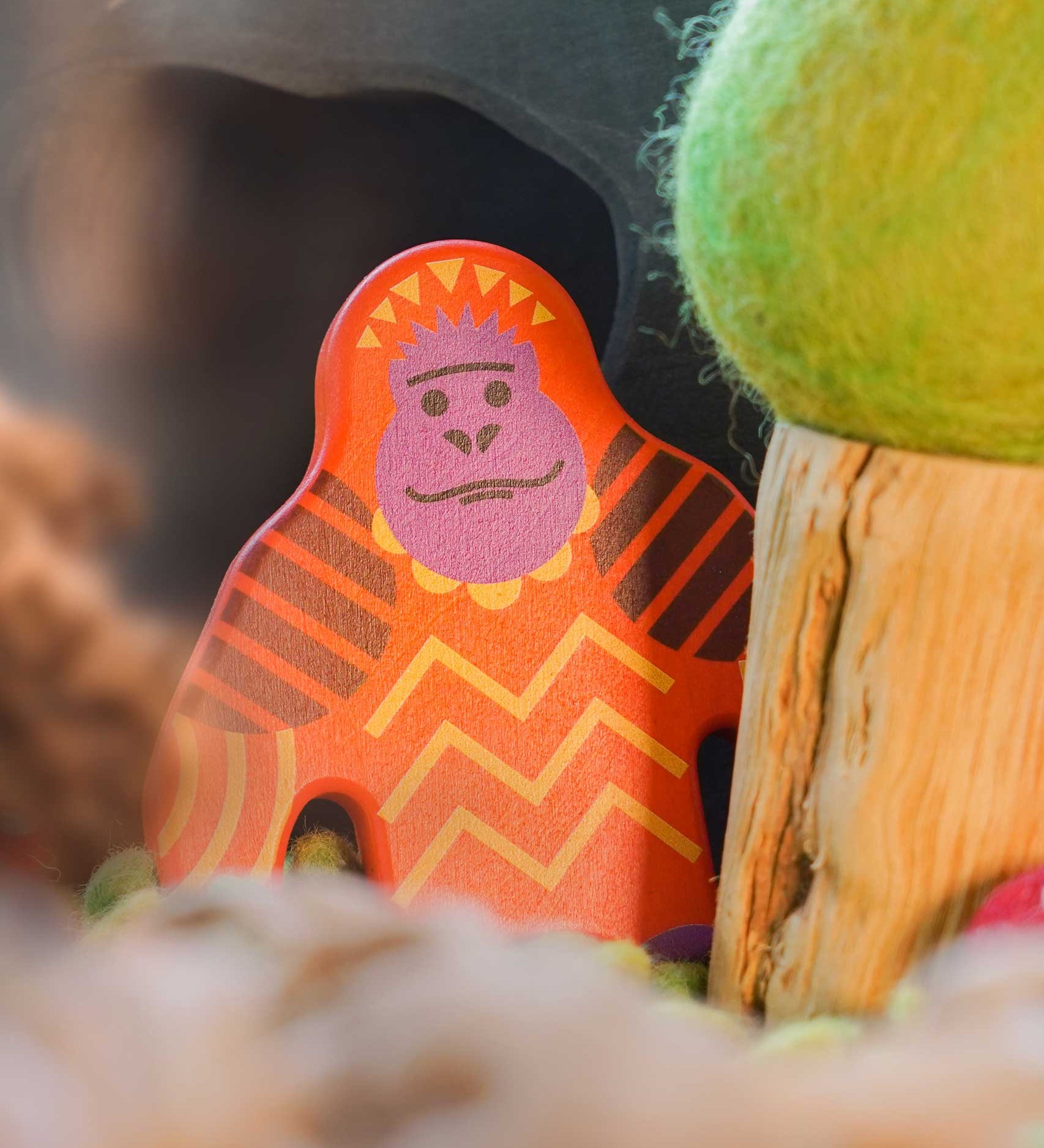 A Bajo orangutan Endangered Animals wooden toy Figure placed in a small world play scene at Babipur with an Ostheimer cave in the background and a Papoose tree besides it. 