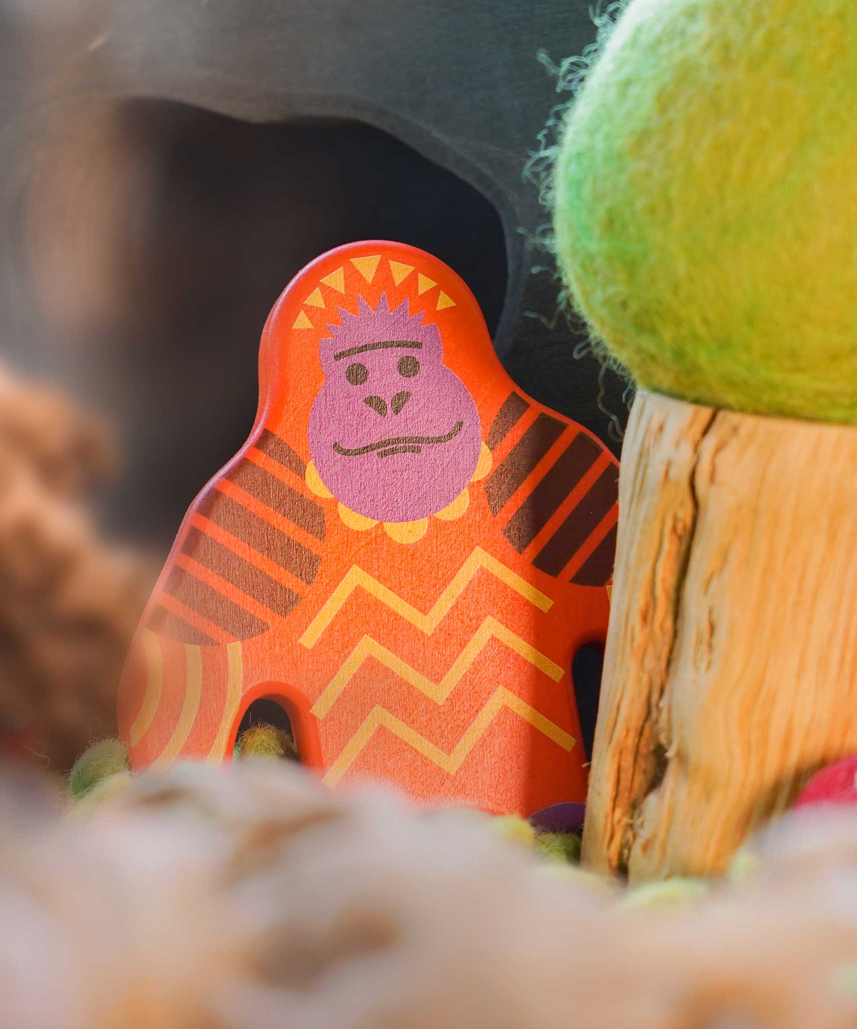 A Bajo orangutan Endangered Animals wooden toy Figure placed in a small world play scene at Babipur with an Ostheimer cave in the background and a Papoose tree besides it. 