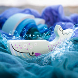 A Bajo Blue Whale Endangered Animals wooden toy Figure placed on Ostheimer cloths with Grimm's waves in the background in the Babipur playroom. These heirloom quality toys by Bajo are part of a wide range of wooden toys available here at Babipur.