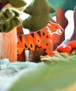 A Bajo tiger endangered wooden toy animal figure placed in a small world play scene with trees and green coloured cloths. These heirloom quality toys by Bajo are part of a wide range of wooden toys available here at Babipur. 