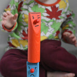 A child stacking pieces from the Bajo Fellow Skittles wooden toy game on top of each other.  These heirloom quality toys by Bajo are part of a wide range of wooden toys available here at Babipur.