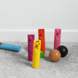 Bajo Fellow Skittles wooden toy game. Six coloured wooden skittles decorated with faces with red noses. The set comes with two wooden balls.  These heirloom quality toys by Bajo are part of a wide range of wooden toys available here at Babipur.
