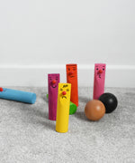 Bajo Fellow Skittles wooden toy game. Six coloured wooden skittles decorated with faces with red noses. The set comes with two wooden balls.  These heirloom quality toys by Bajo are part of a wide range of wooden toys available here at Babipur.