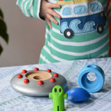Bajo Alien Flying Saucer placed on a table with all the pieces separated. 