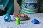 The pieces from the Bajo Alien Flying Saucer set separated and placed on a table.