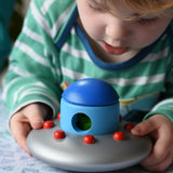 A child lifting up the Bajo Alien Flying Saucer set.