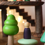 Large green bobble tree from the Bajo forest wooden toy tree figure set placed next to a Grapat animal Nin on a green Bajo pebble in a small world play scene.