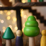 Trees from the Bajo green forest tree set lined up next to Grapat animal crew peg dolls.