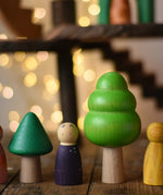 Trees from the Bajo green forest tree set lined up next to Grapat animal crew peg dolls.