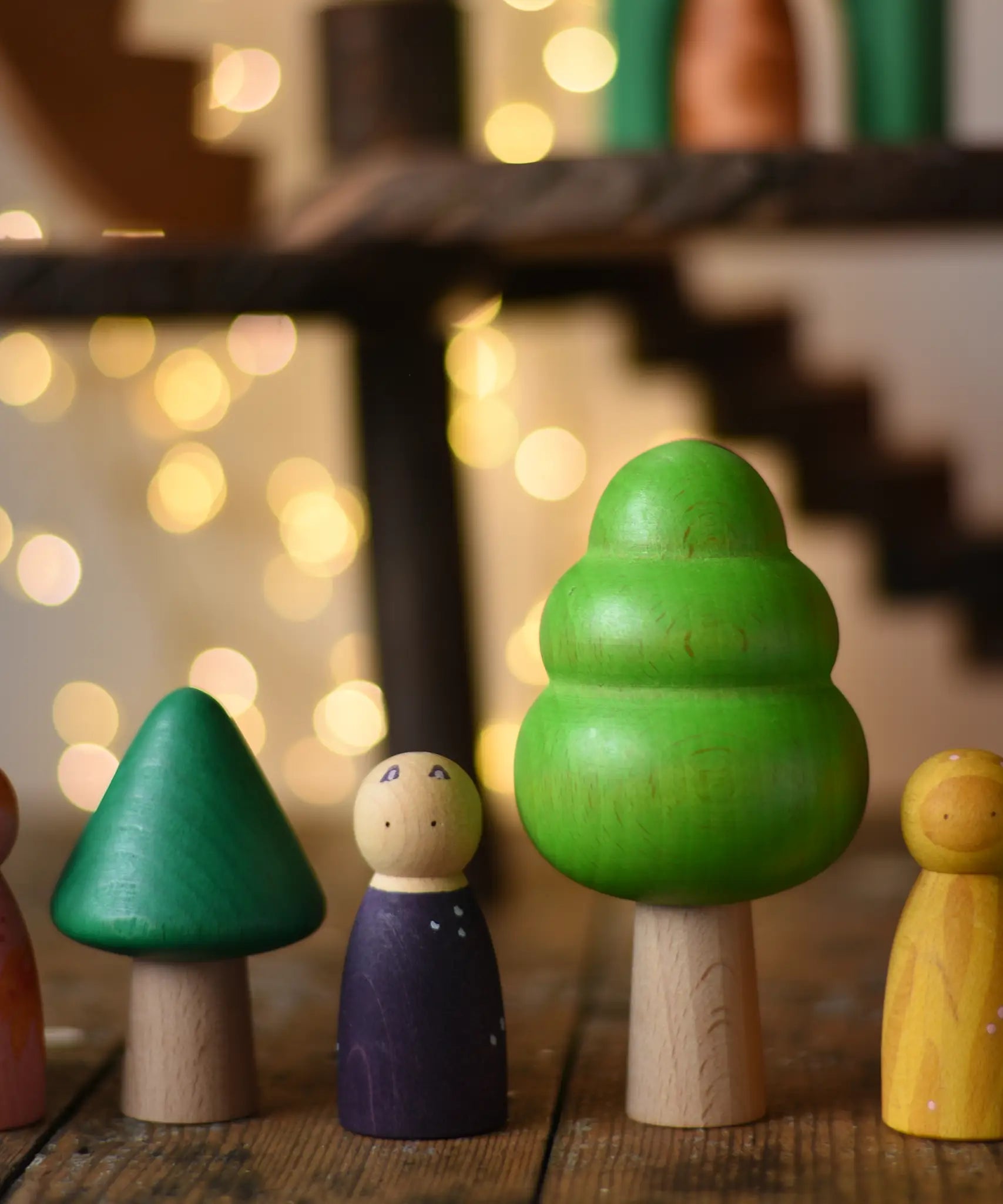 Trees from the Bajo green forest tree set lined up next to Grapat animal crew peg dolls.