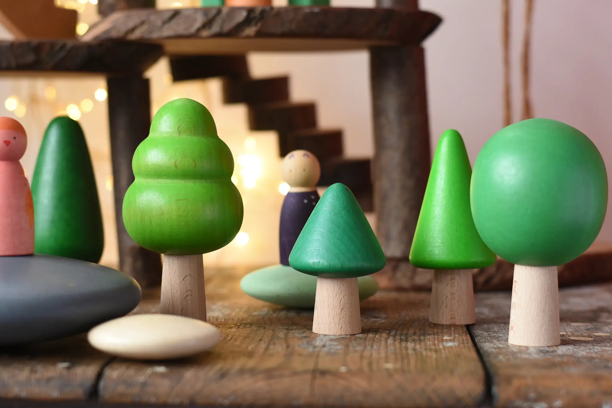 Bajo green forest tree set used in a small world play scene with Bajo pebbles and Grapat animal Nins. magic wood adventure playground in the background. 