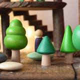 Bajo green forest tree set used in a small world play scene with Bajo pebbles and Grapat animal Nins. magic wood adventure playground in the background. 