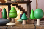 Bajo green forest tree set used in a small world play scene with Bajo pebbles and Grapat animal Nins. magic wood adventure playground in the background. 