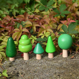 Bajo green forest tree set - 5 wooden trees in a set of 5 placed on a concrete surface outdoors.
