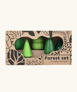 Bajo forest wooden toy tree figure set. Five green trees in different heights and shapes shown in their cardboard packaging box.