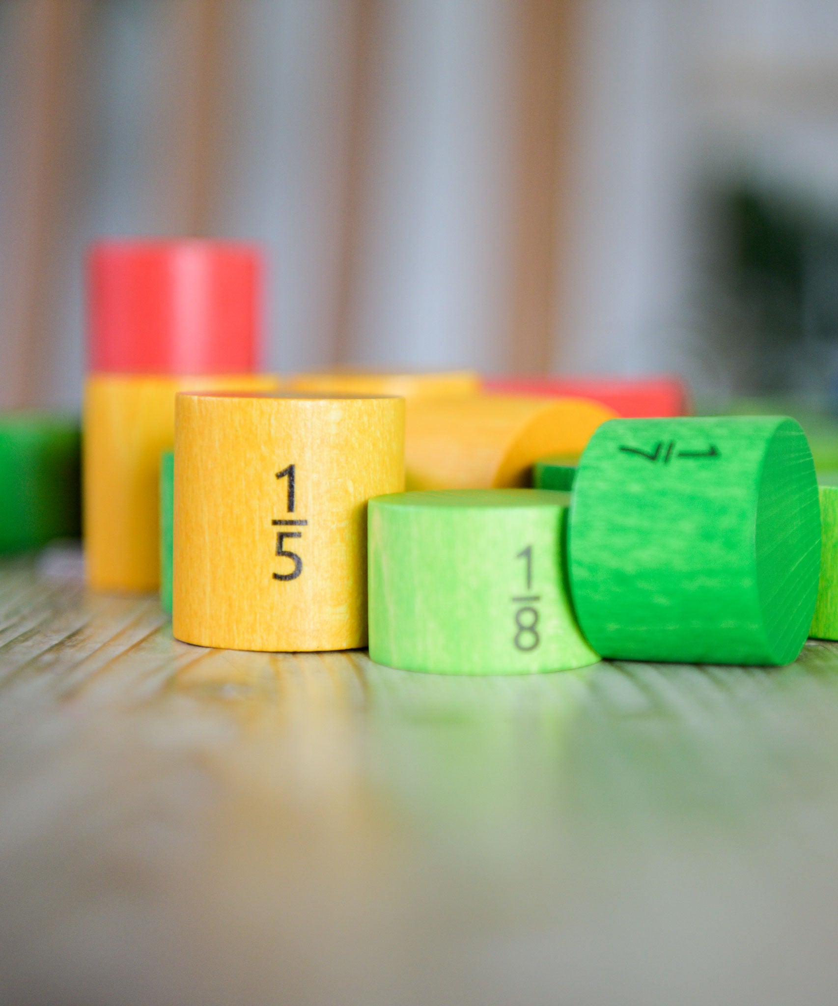Bajo Fractions Set. A set of coloured wooden blocks marked with fractions on each block. These heirloom quality toys by Bajo are part of a wide range of wooden toys available here at Babipur.
