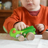 A child playing with the Bajo green Grasshopper wooden toy. These heirloom quality toys by Bajo are part of a wide range of wooden toys available here at Babipur.