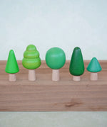 Bajo forest wooden toy tree figure set. Five green trees in different heights and shapes.