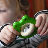 Bajo green Frog Rattle wooden baby in a child's hand in the Babipur playroom