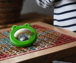 Bajo green Frog Rattle wooden baby toy placed on a rattan stool in the Babipur playroom,