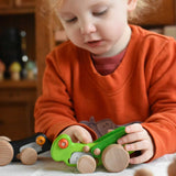 A child playing with the Bajo green Grasshopper wooden toy. These heirloom quality toys by Bajo are part of a wide range of wooden toys available here at Babipur.
