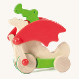 Bajo green pull along dragon wooden toy available at Babipur. Features two wheels at the front and back and red wing that move along with the front wheels