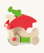 Bajo green pull along dragon wooden toy available at Babipur. Features two wheels at the front and back and red wing that move along with the front wheels