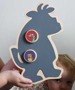 A Bajo owl and snake magnets placed on a Gruffalo shaped board. A close up of a Bajo gruffalo owl magnet stuck onto a Triclimb biri board. These magnets are part of a range of Bajo wooden toys available at Babipur. 