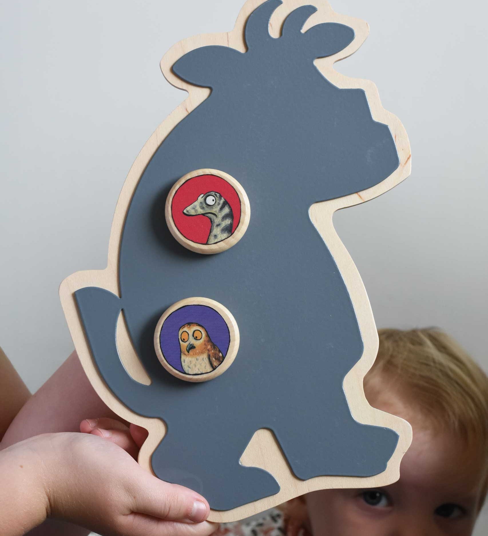 A Bajo owl and snake magnets placed on a Gruffalo shaped board. A close up of a Bajo gruffalo owl magnet stuck onto a Triclimb biri board. These magnets are part of a range of Bajo wooden toys available at Babipur. 