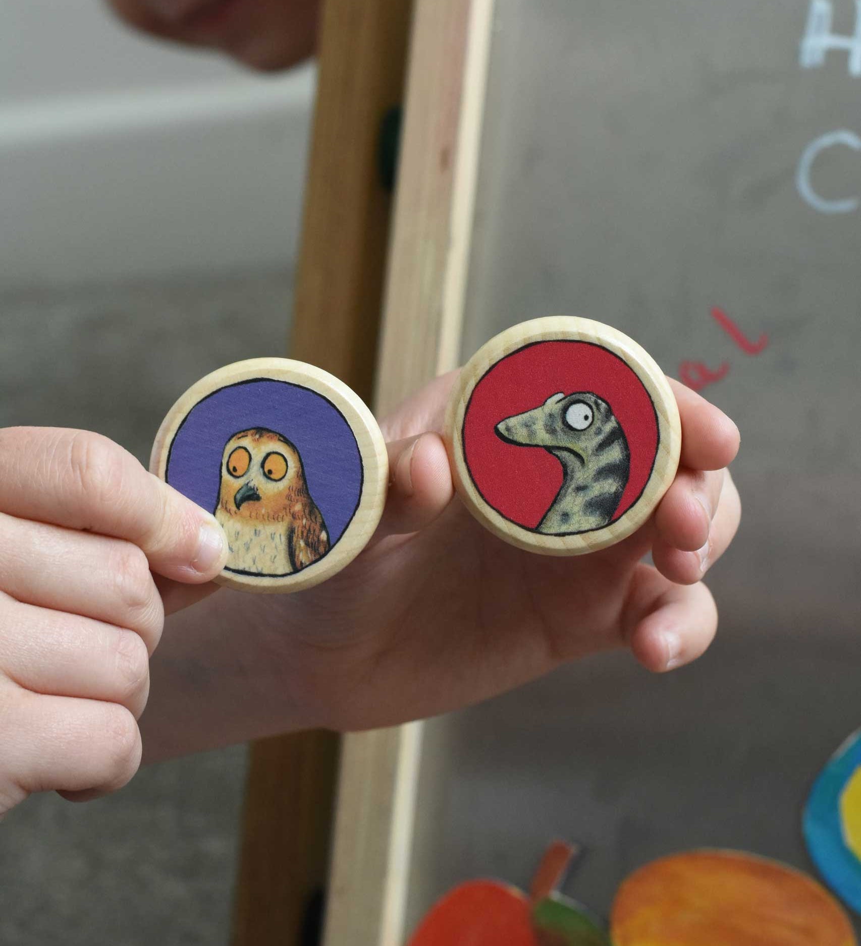 An owl and snake Bajo Gruffalo magnet in a child's hand. These magnets are part of a range of Bajo wooden toys available at Babipur. 
