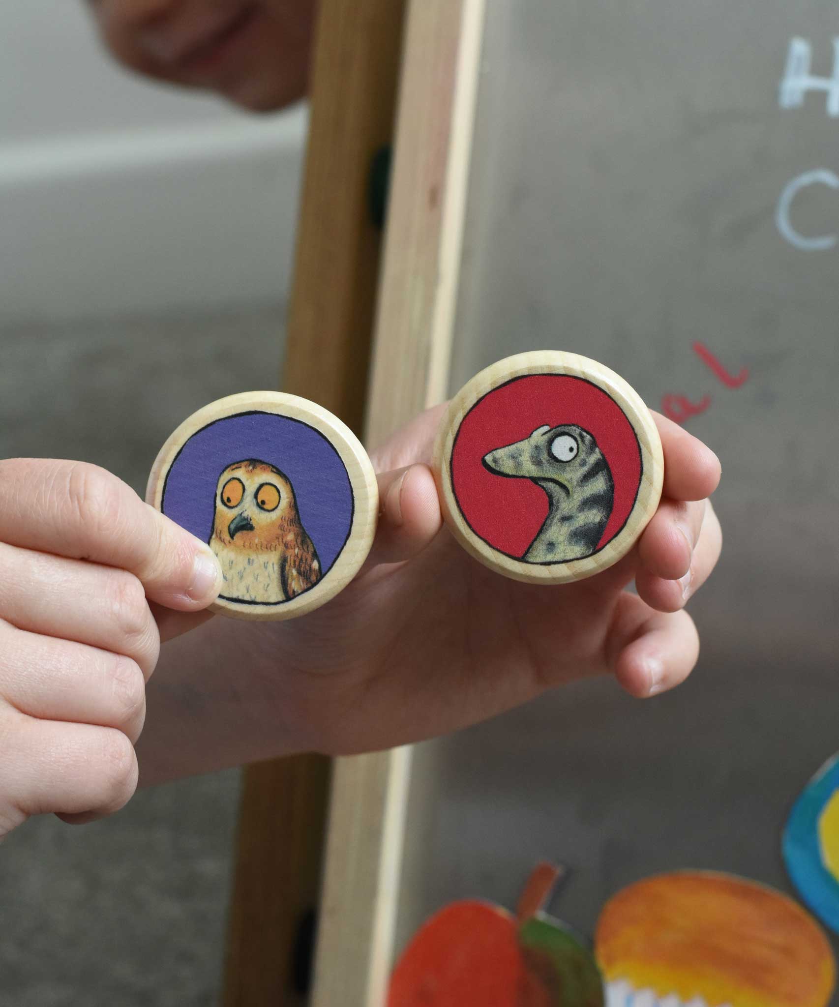 An owl and snake Bajo Gruffalo magnet in a child's hand. These magnets are part of a range of Bajo wooden toys available at Babipur. 