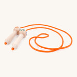 A wooden gruffalo skipping rope with orange rope on a cream background