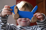 Bajo blue dachshund puppy in a child's hands in the Babipur playroom. 