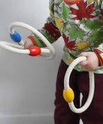 A close up of a child holding the rope hoops from the Bajo Fellow Hoopla Game Set. A traditional style wooden game set that can be used for hoopla and skittles. These heirloom quality toys by Bajo are part of a wide range of wooden toys available here at Babipur.